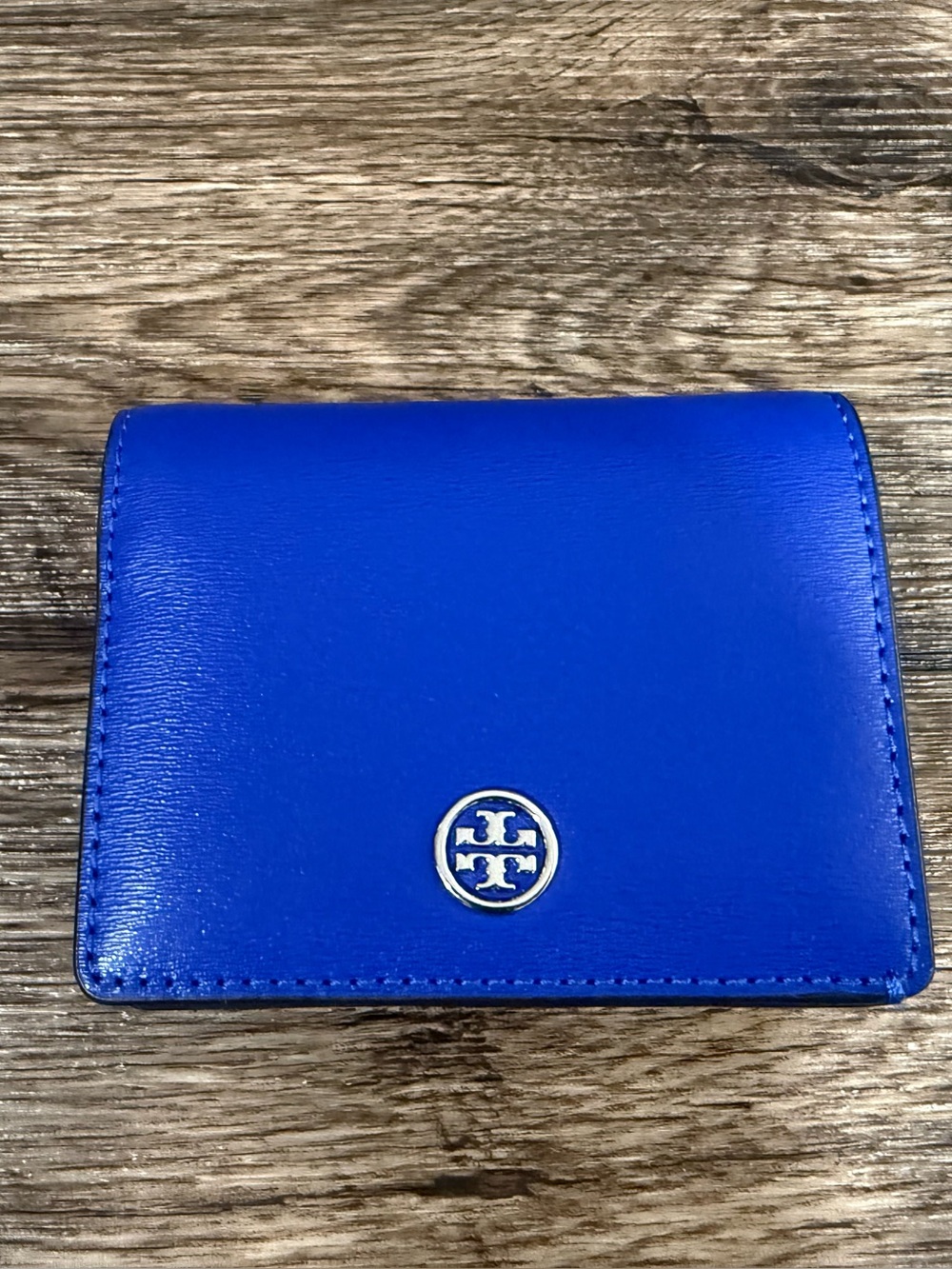 royal blue leather Tory Burch compact wallet accented polished silver-tone logo